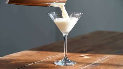 A refreshing cocktail being poured into a martini glass Stock Video - Powered by Adobe
