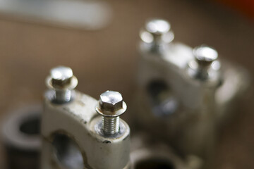 Close up detail of metal engine cylinder head with shiny screw and bolt. mechanical car part for auto maintenance, service, and repair in garage workshop