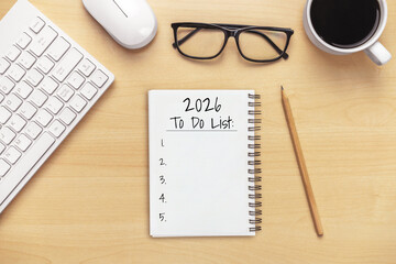 2026 Happy New Year Resolution Goal List and Plans Setting - Business office desk with notebook written about plan listing of new year goals and resolutions setting. Change and glee concept.