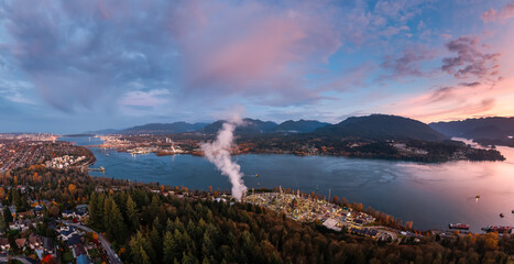 Fototapeta premium Aerial Sunset Over Burnaby City By Water With Mountains And Forest In Greater Vancouver Canada