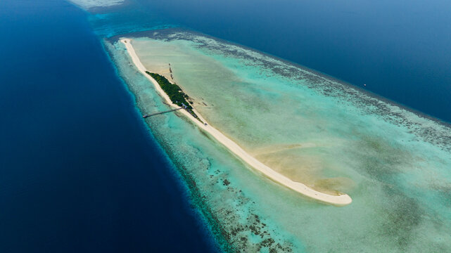 Aerial drone of tropical island on the atoll and coral reef. Timba Timba islet. Tun Sakaran Marine Park. Borneo, Sabah, Malaysia.