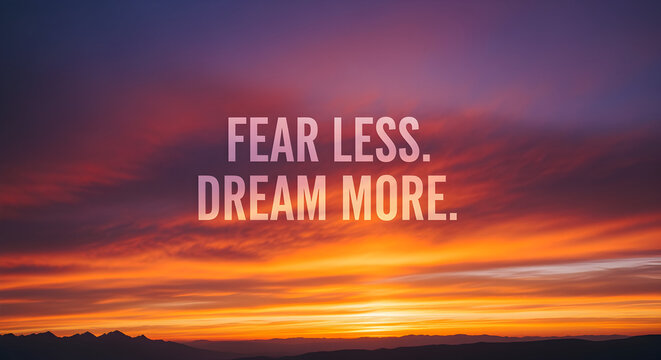 Inspiring vibrant sunset sky with "Fear Less. Dream More." motivational message for ultimate aspiration and success - Powered by Adobe