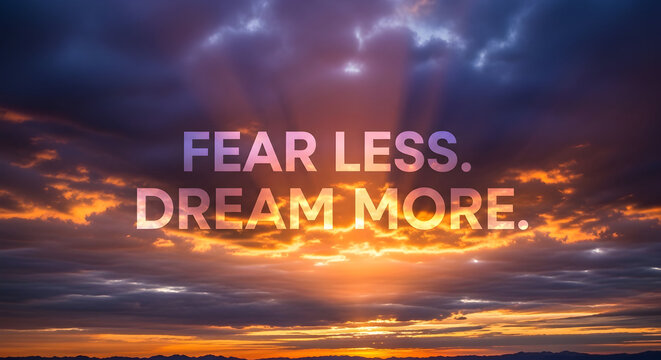 Inspiring sunrise sky with bold text 'FEAR LESS. DREAM MORE.' encouraging ambition and hope for a brighter future