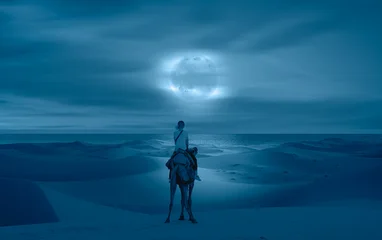 Fotobehang Kameel A woman riding a camel across the thin sand dunes of the in Western Sahara Desert - Beautiful sand dunes in orange desert at sunrise with crescent moon - Sahara, Morocco   © muratart