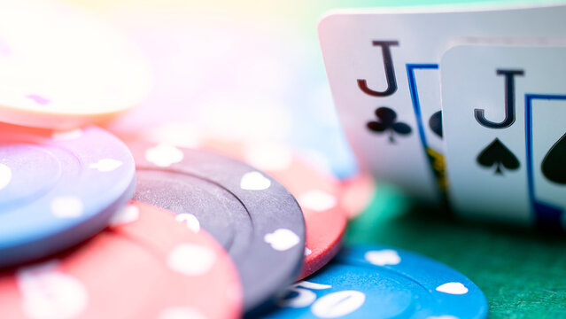 Two jackdaws on the card table in a poker game. A couple of Volts is a good hand to start playing poker. High quality photo - Powered by Adobe