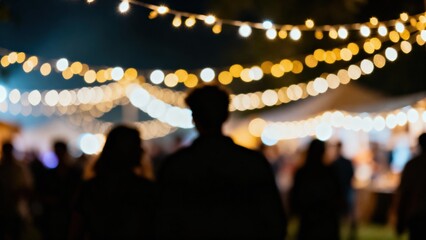 Silhouettes against bright bokeh lights at a festive night event.