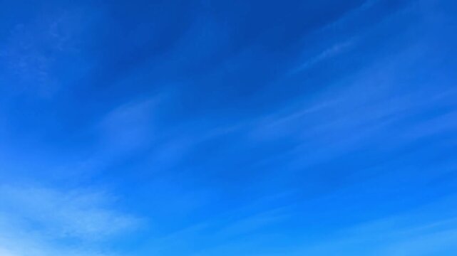 A bright and expansive image of a clear, blue sky with wispy clouds, creating a sense of openness and tranquility Stock Video