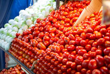 Freshly Harvested Roma Tomatoes and Onions Displayed at Farmer Market