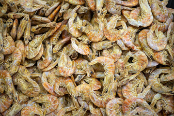 A close up and overhead view of a pile of dried shrimp.
