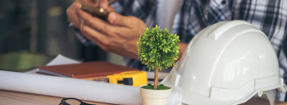 Banner man construction engineer writing notepad wear plaid shirt safety white hard hat at construction site. Panorama Architecture Female design drawing civil constrcution real estate copy space