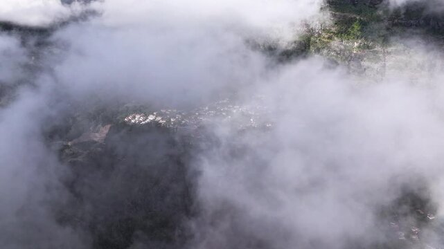 Drone time lapse of mountain fog moving over scenic Curral das Freiras parish