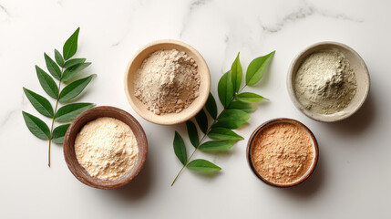 “Flat lay of cosmetic clay products with dry powder and mixed clay mask, styled with a green leaf on a marble surface.”