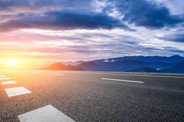 Empty asphalt highway road and mountain range with beautiful sky clouds natural landscape at sunset