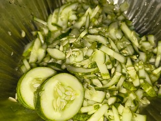 Freshly sliced cucumbers ready for salad preparation