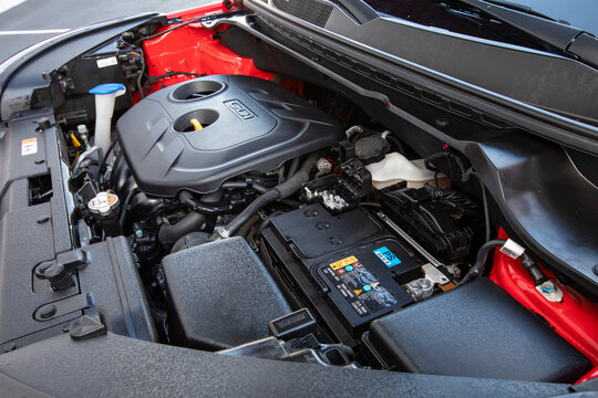 Portland, OR, USA-Jan 13, 2021- engine bay of 2017 red Kia Soul South Korean hatchback showing GDI 2.0L Nu MPI motor cover battery fluid reservoirs and surrounding components in daylight