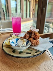 Breaded chicken with smoked sour cream served in a bowl