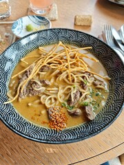 Japanese curry soup wuth beef, noodle, sesame served in a cute bowl 
