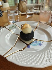 Orange yuzu mousse dessert on a beautiful plate in a restaurant 