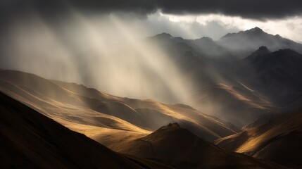 sunbeams. Sunbeams breaking through dark storm clouds over a mountain range, illuminating slopes. travel magazines, destination branding, designed for travel destination branding.