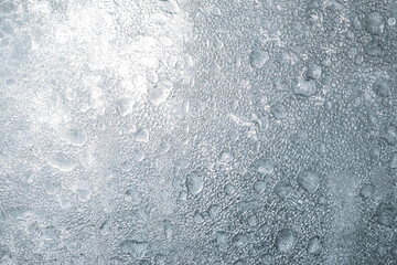 A grey surface with water droplets on it