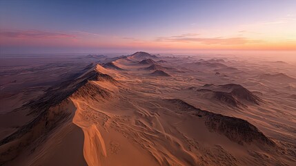 Aerial View Of Desert Landscape With Mountains And Sparse Trees At Sunset