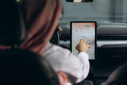 Person navigating middle east map in car on screen
