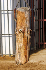A large log is hanging from a chain