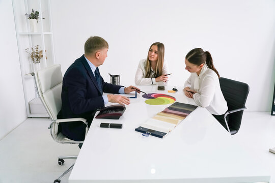 Business meeting focused on design ideas with color palettes and fabric samples