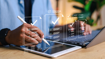 Person using digital tablet with stylus and laptop, with virtual checklist and task management interface overlay. Concept of productivity, workflow, digital forms, and online organization.