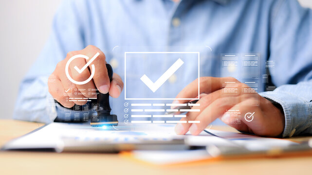 Businessman stamping approved documents with digital checkmark interface. Concept of verification, validation, authorization, electronic document approval, and business compliance.