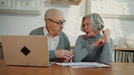 Senior woman feeling sad of debts and expenses, old husband supporting her. Portrait of elderly spouses at home kitchen, aged people planning family budget, economy and crisis, grey-haired lady crying - Powered by Adobe