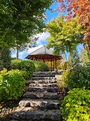 stone steps to a wooden gazebo in an autumn park