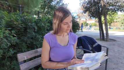 Calm woman reading quietly on a bench in a serene park setting while enjoying a moment of solitude - Powered by Adobe