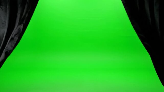View of a green screen stage framed by black curtains. Ready for video production