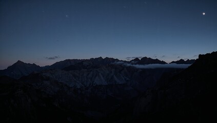 Serene Twilight Over Rugged Mountain Range Under Starry Sky