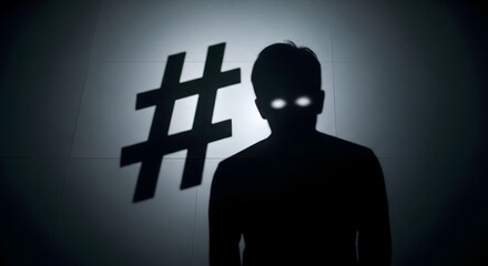 A dark silhouette of a person with glowing eyes standing in front of a large hashtag symbol on a wall, creating a mysterious and ominous atmosphere