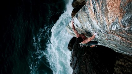 Dramatic coastal climb with waves crashing below—adventure sports, courage and raw nature energy for outdoor brands, tourism boards and motivational storytelling about pushing limits