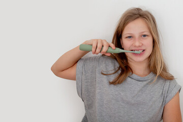 Preteen girl brushing teeth in natural lifestyle scene