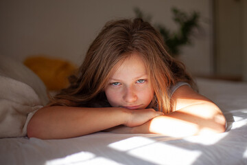 Happy Teenage Girl Relaxing in Bed in the Morning