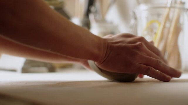 Pottery hands shaping ceramic art in a cozy workshop setting today