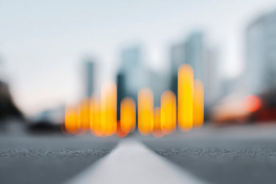 Golden bar chart over city traffic at sunset, symbolizing business growth, finance success, and urban data analytics concept.