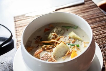 Coconut Milk Vegetable Soup with Tofu and Carrots in Southeast Asian Culinary Presentation