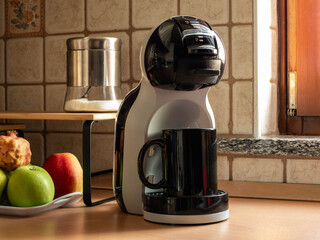 Setting with latte machine and fresh fruit in the background