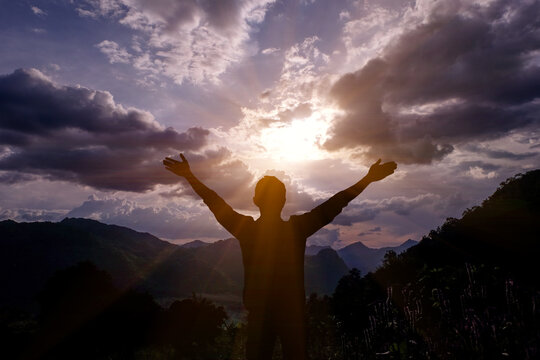 silhouette of a man with arms outstretched - Powered by Adobe