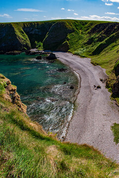 Stonehaven, Aberdeenshire, Scotland, United Kingdom: aerial and panoramic view of the beach under Dunnottar Castle, ruined medieval fortress on a rocky headland in the northeast coast
