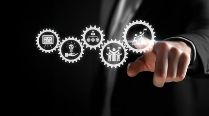 Businessman touching virtual cogwheels representing a business process workflow, including strategy, innovation, organization, and achieving goals.