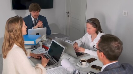 director discusses strategy, caucasian leader guides strategic planning session, caucasian director energetically gestures during collaborative strategic planning meeting with laptops and coffee