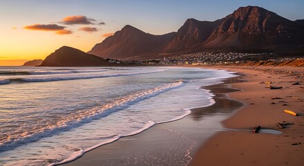Beach coastline with mountains at sunset