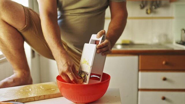 Chef grating ginger in domestic kitchen