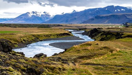 Icelandic River Valley Landscape with Distant Snow-Capped Mountains.